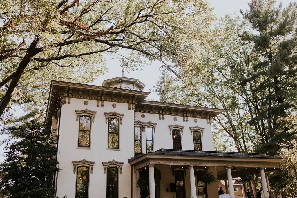 Peterson-Dumesnil House exterior with columns and tree canopy